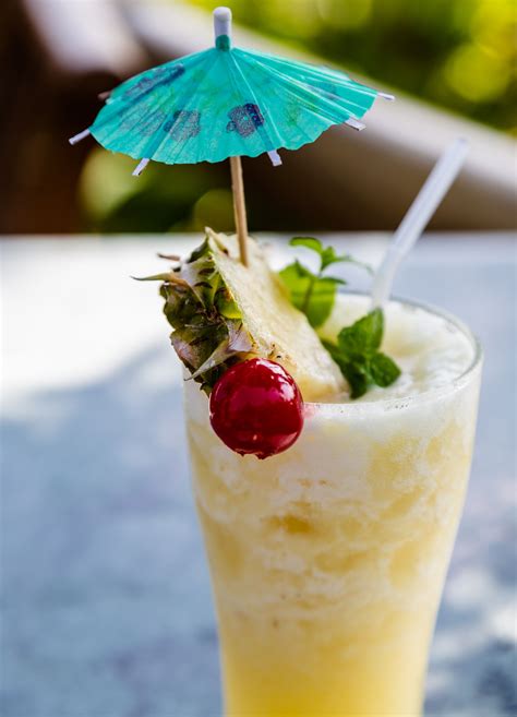 A Drink With Strawberries And An Umbrella On The Top Is Sitting On A Table