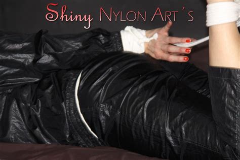 Blonde Woman Is Tied Up With Rope While Gagged In Black Nylon Rainwear