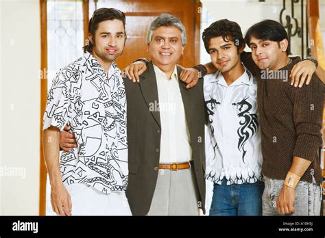 Portrait Of A Mature Man And His Three Sons Smiling Stock Photo Alamy
