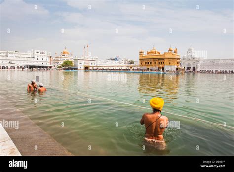 Sikh Pilgrims Bathing In Nectar Pond At Golden Temple In Amritsar