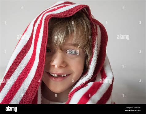 Portrait Of A Smiling Boy With Red And White Towel On His Head Stock