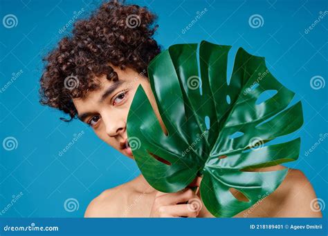 Handsome Man With Curly Hair Naked Shoulders Green Leaf Clear Skin