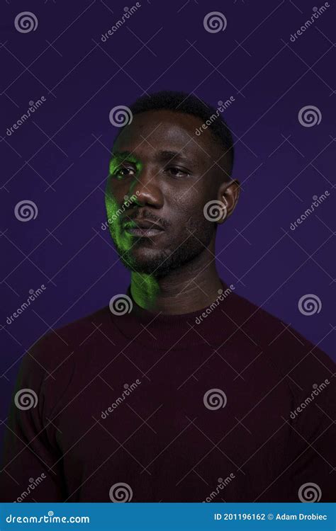 Young Black Man With Stoic Expression Looking Away Stock Photo Image