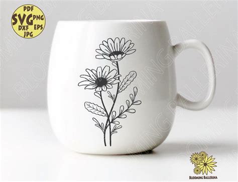 a white coffee cup with flowers drawn on it