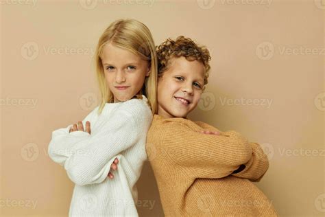 Portrait of cute children hug entertainment posing friendship beige ...