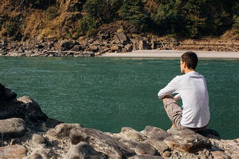 Man Sitting By The Ganges River Del Colaborador De Stocksy Mosuno