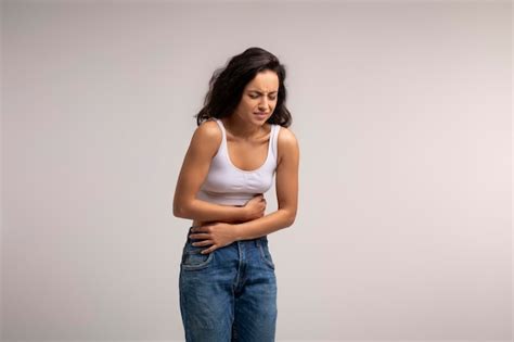 Premium Photo Brunette Woman Touching Aching Abdomen Having Painful Stomachache