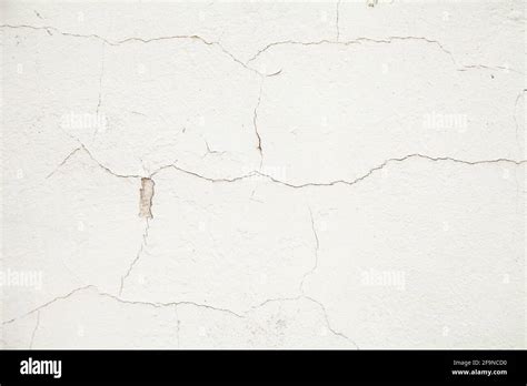 White Wall With Cracks Cracks Texture On A White Abstract Background