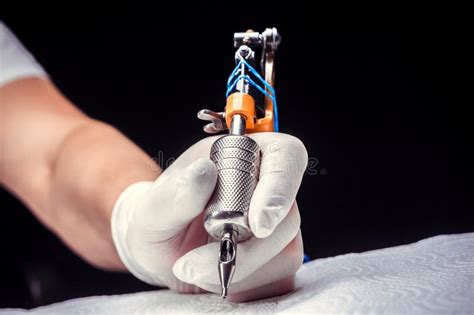 Hand Of A Tattooist Holding A Tattoo Gun Stock Image Image Of