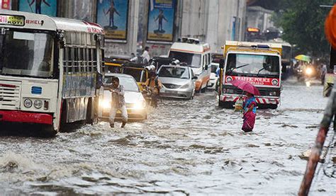 A Car Drives During Heavy Rain Through A Flooded Street In Hyderabad