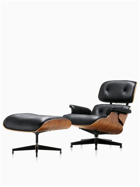 An Eames Lounge Chair And Ottoman In Black Leather