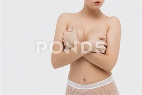 Beautiful Slim Woman Covering Her Nude Breast Isolated On White