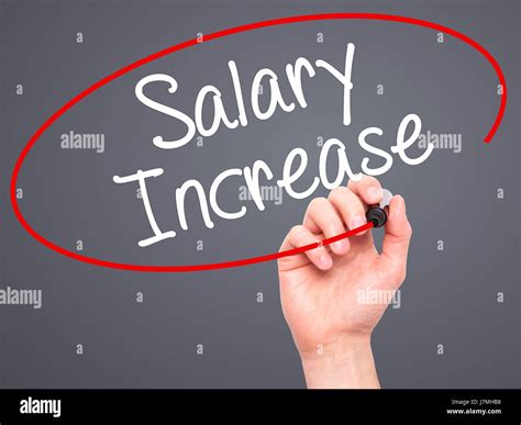 Man Hand Writing Salary Increase With Black Marker On Visual Screen