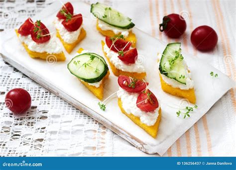 Vegetarian Canapes From Polenta With Cheese Vegetables And Cress On A