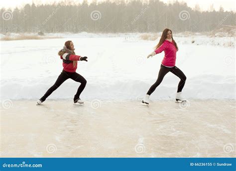 Coach Of Figure Skating With Apprentice Practise At The Frozen Lake