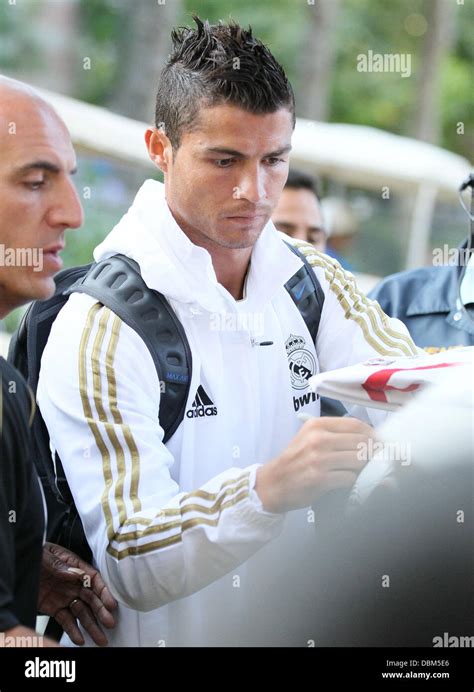 Real Madrid forward Cristiano Ronaldo signs autographs for fans as he ...