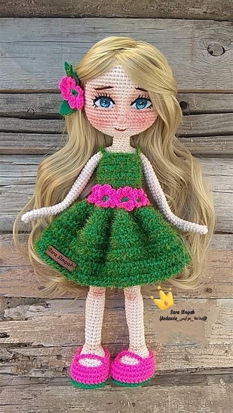 The Doll Is Wearing A Green Dress And Pink Shoes