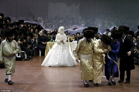 Ultra Orthodox Jewish bride is led by a ribbon to her wedding as ...