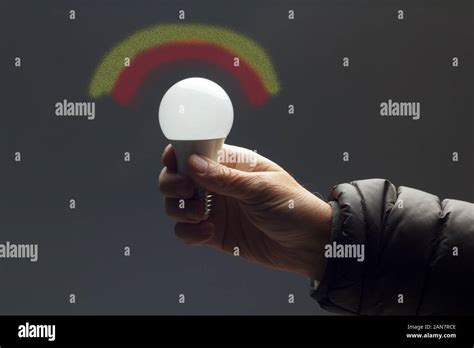 Energy Saving Daylight Bulb In The Hand Of An Adult Bulb Prepared To