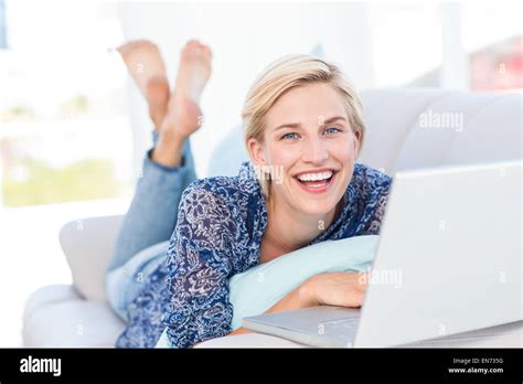 Pretty Blonde Woman Lying On The Couch And Using Her Laptop Stock Photo Alamy