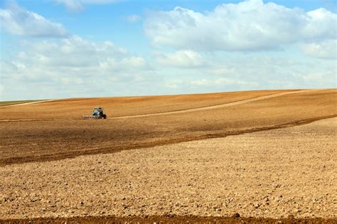 Premium Photo | Tractor plowing field