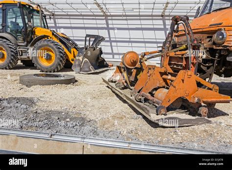 Plate Compactor Is Mounted To The Truck Compacting Sand At Road