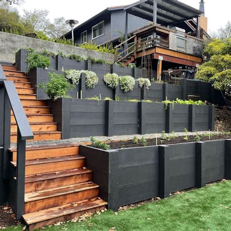 An Outdoor Garden With Wooden Steps And Plants Growing On The Side Of