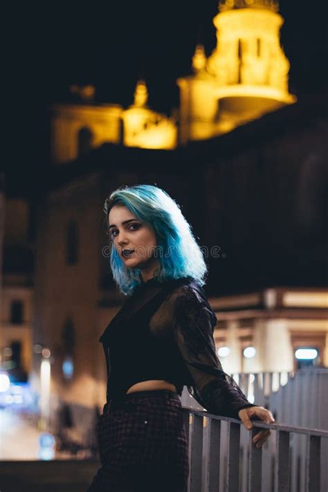 Miserable Female With Blue Hair Standing On A Bridge At Night Stock