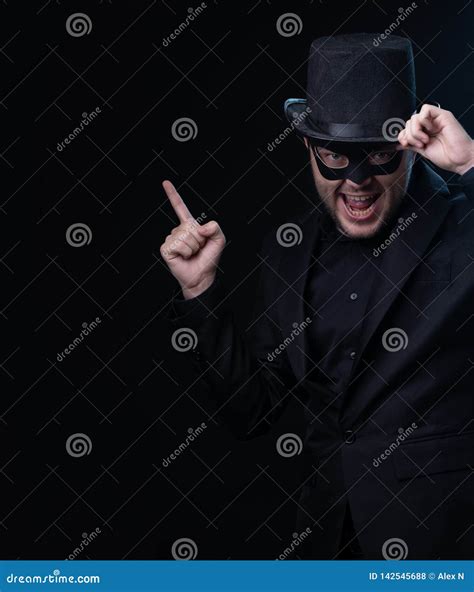 Man In Black Mask Jackethat On Empty Black Background Stock Photo