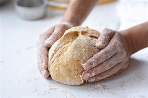 Premium Photo Cropped Hands Kneading Dough On Table