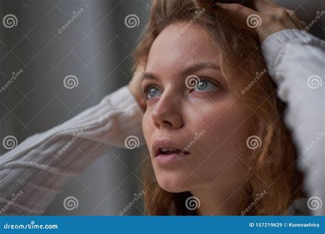 Portrait Of A Beautiful Curly Girl The Mysterious Face Of A Woman At The Window Stock Image