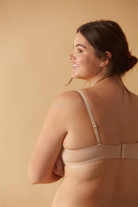 Plus Size Woman Back View Of Happy Full Figured Woman Posing In Beige Lingerie Stock Image