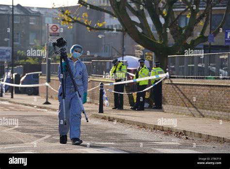 Police Officers At The Scene Near Vine Close Hackney East London Following A Shooting