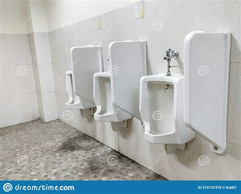 Place Pee Standing Man In A Toilet In The Office Urinal Stock Photo