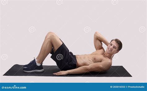 Smiling Millennial Guy With Naked Chest Doing Abs Exercises On Sports