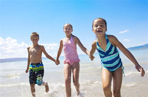 Kids playing at the Beach stock photo. Image of friendship - 25972818