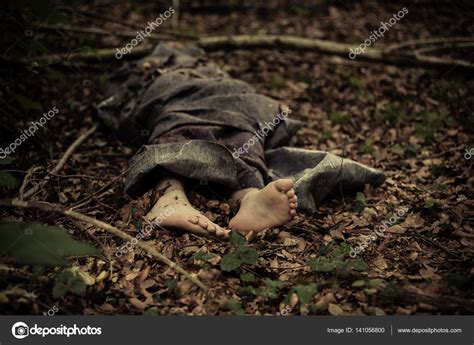 Cadáver de un chico descalzo en el bosque fotografía de stock