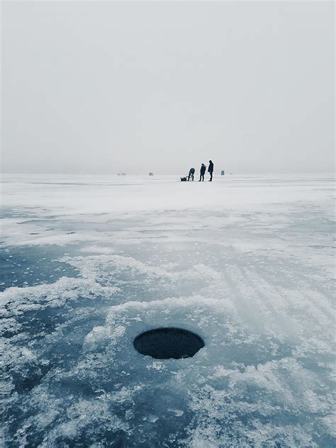 "Fishermen Drilling Ice Fishing Holes On Frozen Lake" by Stocksy ...