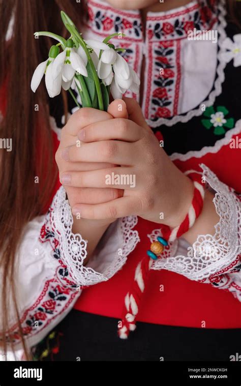 Bulgarian Girl In Traditional Ethnic Costume With Bouquet Spring