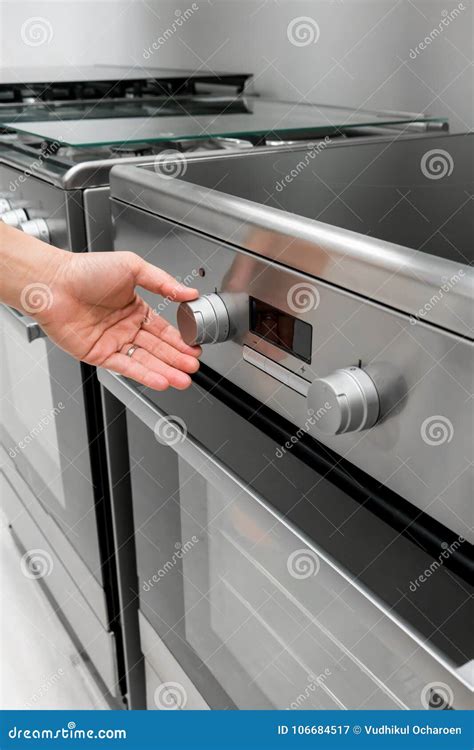 Woman`s Hands Adjusting Heat Button On Oven Machine Stock Image Image