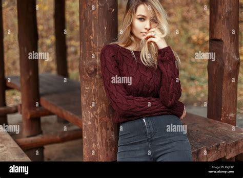 Tr S Belle Jeune Fille Blonde En Jeans Et Chandail Tricot L Gant Pr S De Piliers En Bois Photo