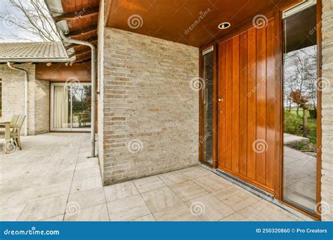 The Facade Of A Brick Building With Wooden Door Stock Photo Image Of