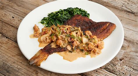 BLACKENED RED SNAPPER WITH CRAWFISH POBLANO CREAM SAUCE AND SAUTÉED