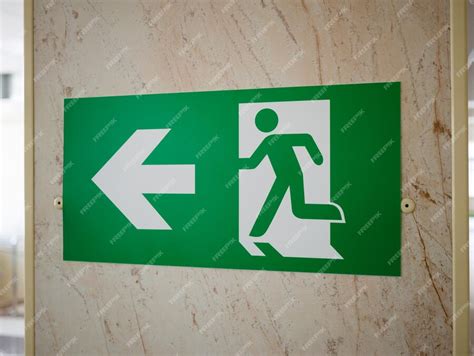 Premium Photo | A green emergency exit sign indicating a safe exit to a ...