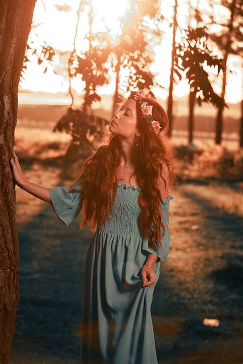 A Woman In Green Off Shoulder Dress Standing Beside Brown Tree · Free