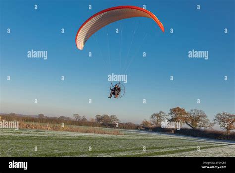 Para Glider Coming Into Land On A Frosty And Icy Field With An Orange