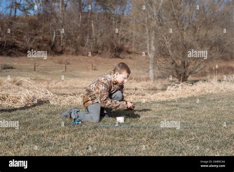 Boy Putting Work On Fishing Rod Near Pond Stock Photo Alamy