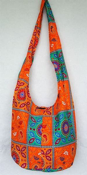 an orange and blue purse hanging on a wall