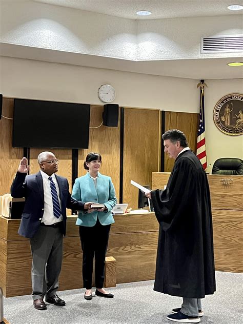 District Attorney Sarah Kirkman, center, presents Tab Hunter, left, to