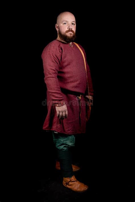 A Bald Bearded Man in a Suit of the Style of the Early Middle Ages ...